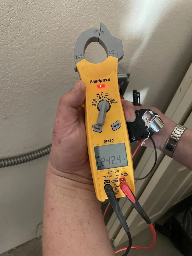 Voltage testing with clamp meter during Outlet Installation in Hickory Creek